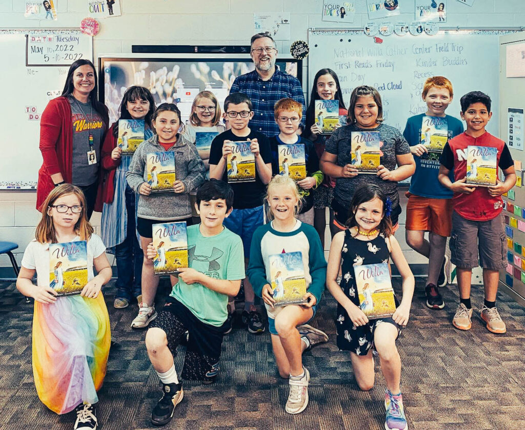 Red Cloud third graders pose with their Willa Cather books gifted by Red Cloud Community Fund.